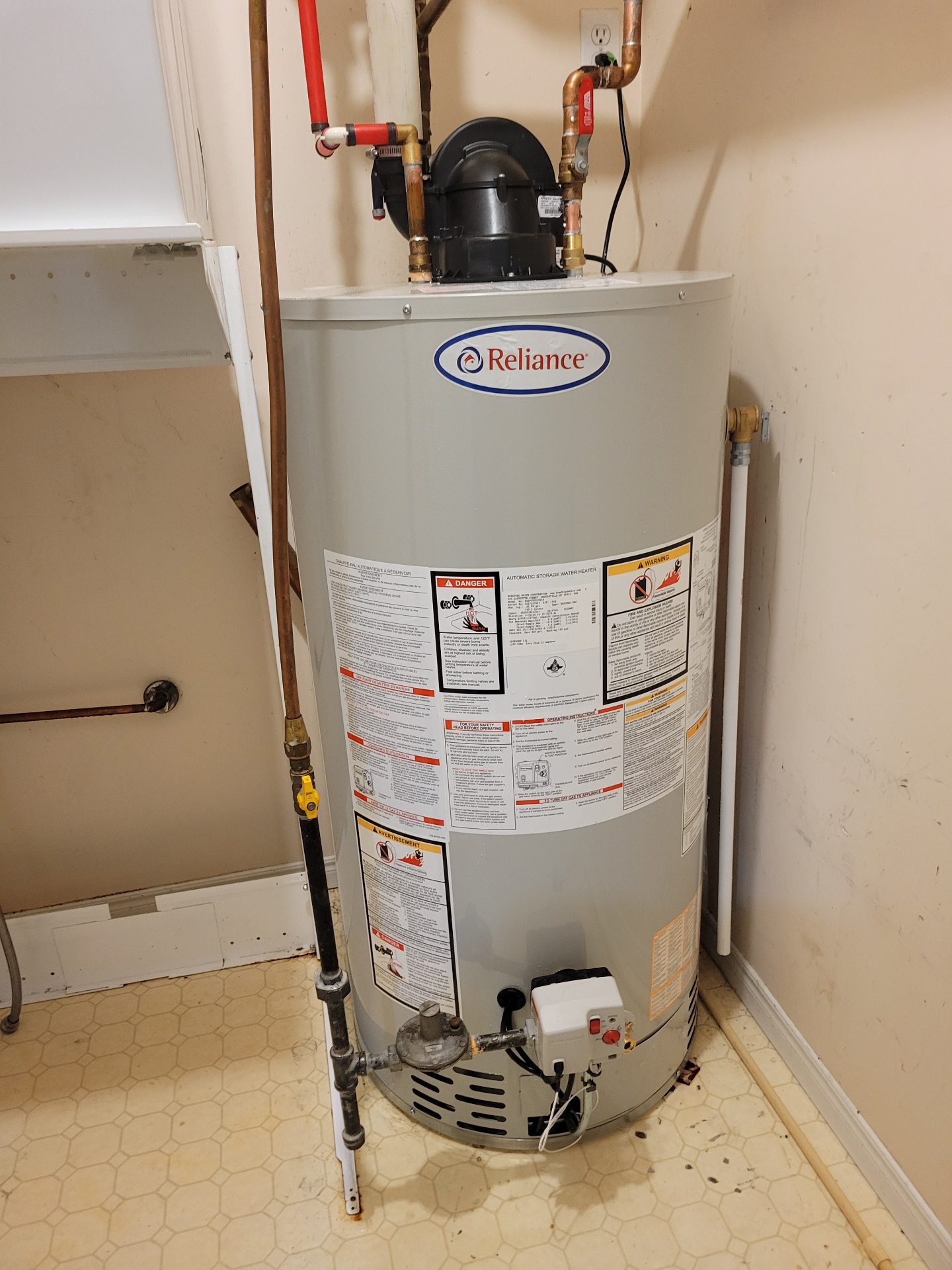 Reliance tank water heater installed in a utility room