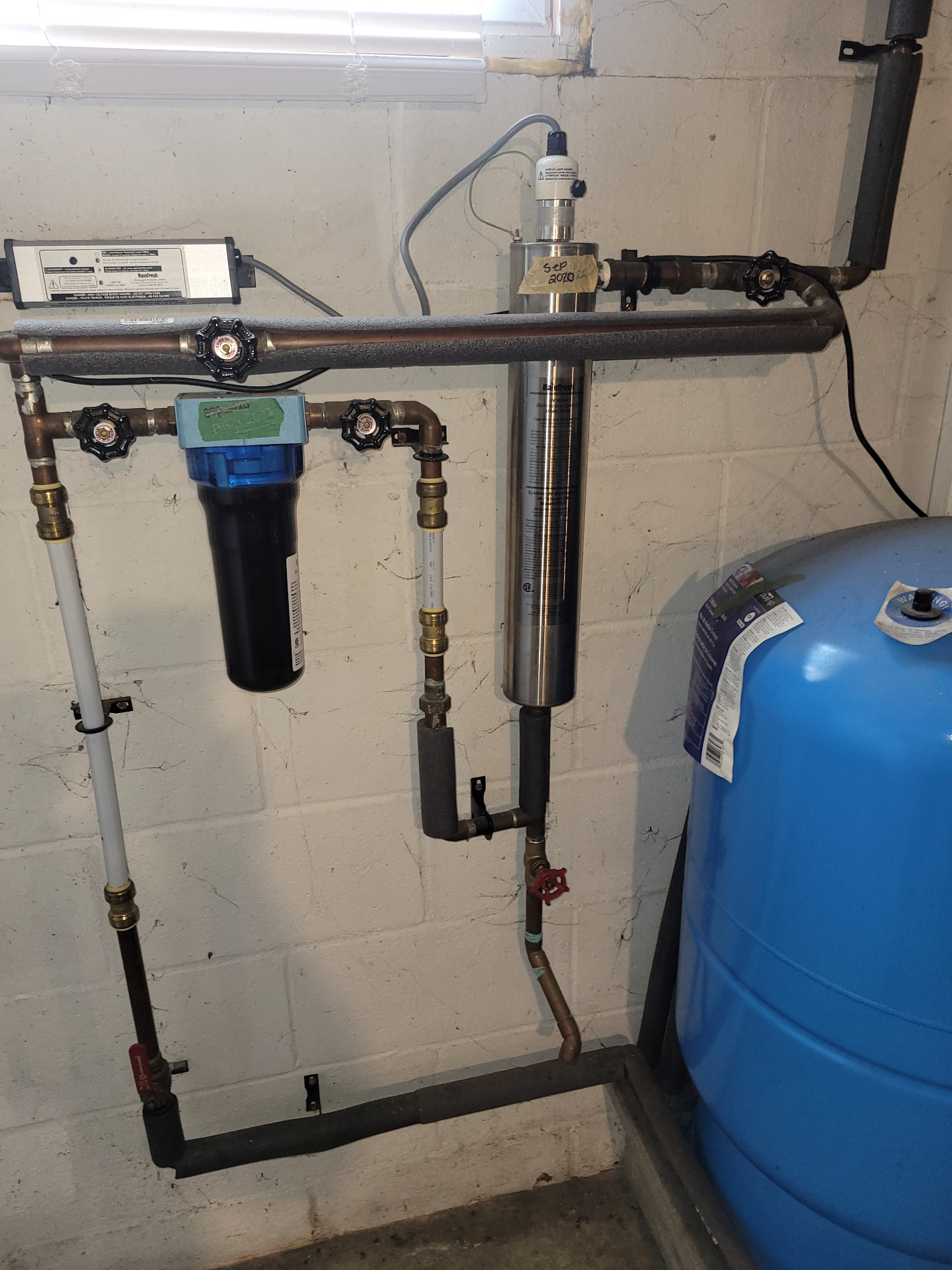 Stainless water treatment system with a blue pressure tank