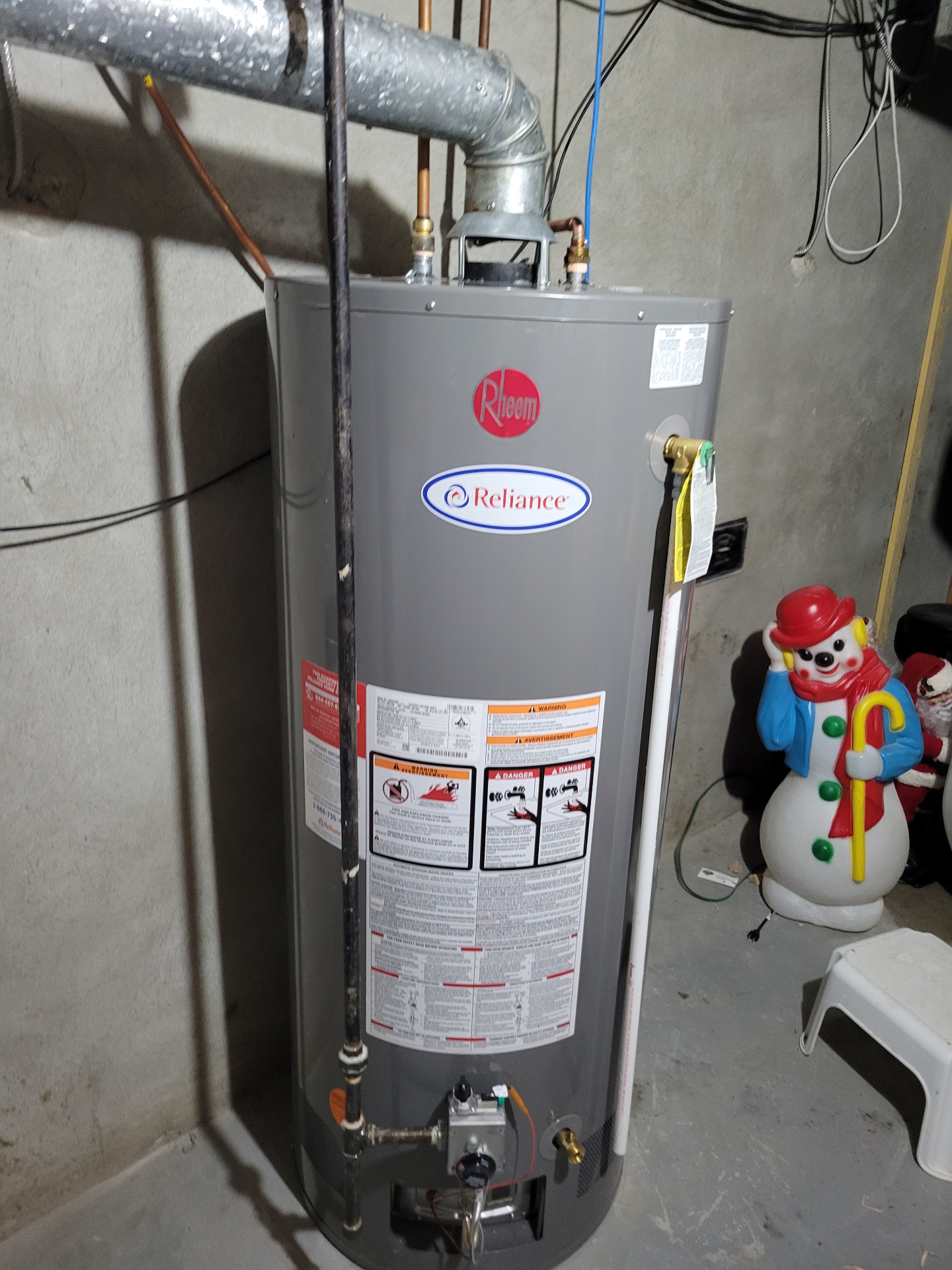 Rheem tank water heater installed in a basement