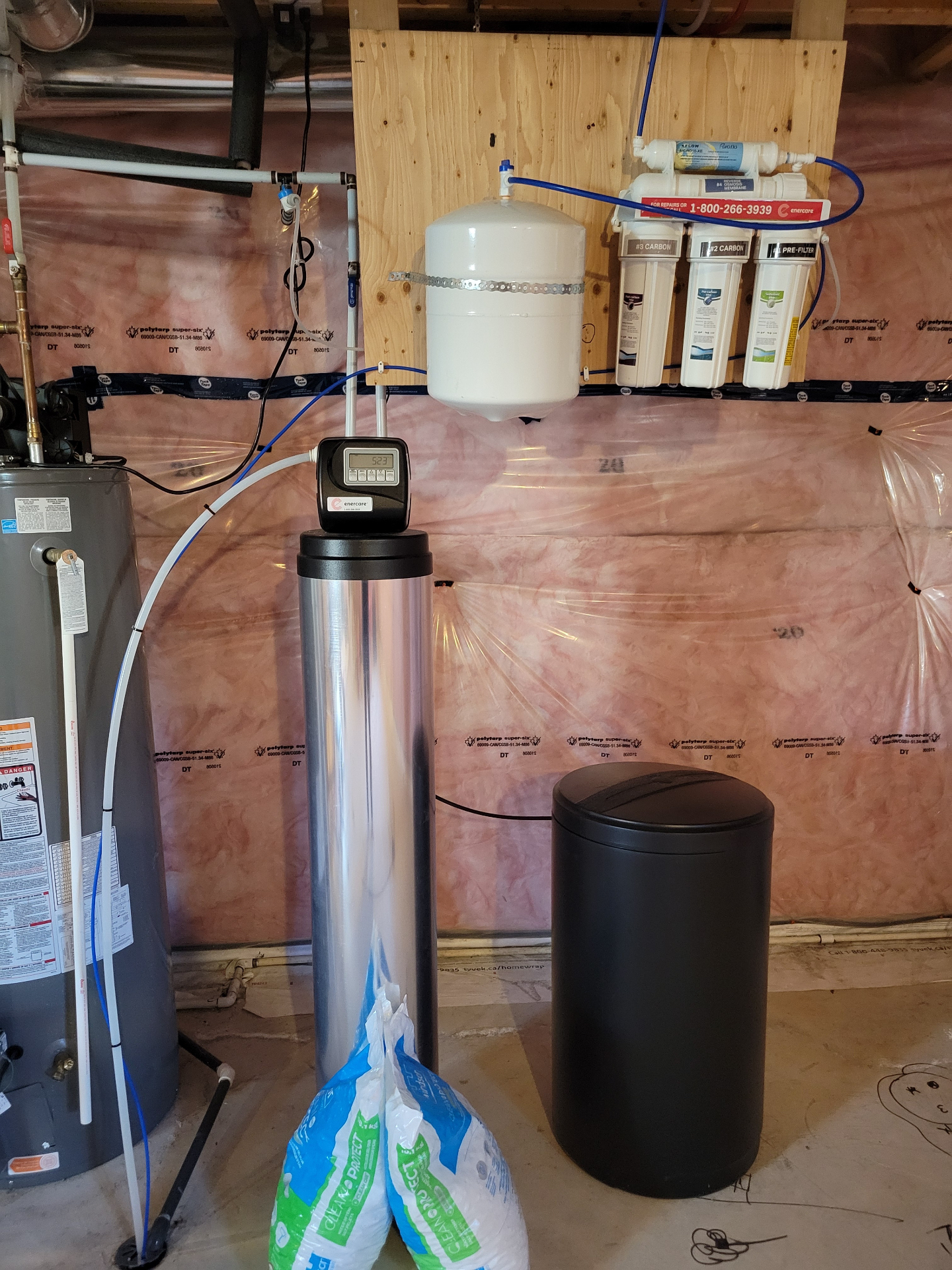 Reverse osmosis tank and filter system installed on a utility wall